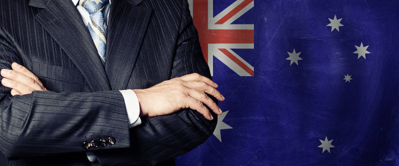 Male hands against Australian flag background, business, politics.