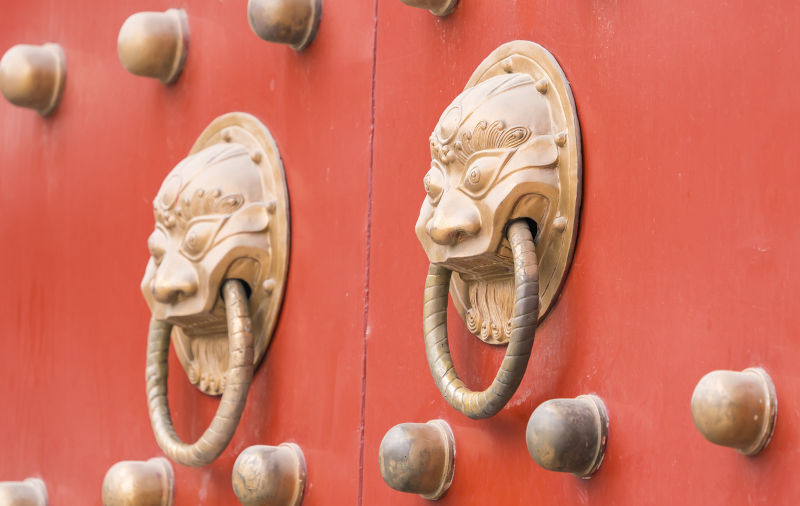 Traditional Chinese Temple with guardian door knockerse with guardian door knockers