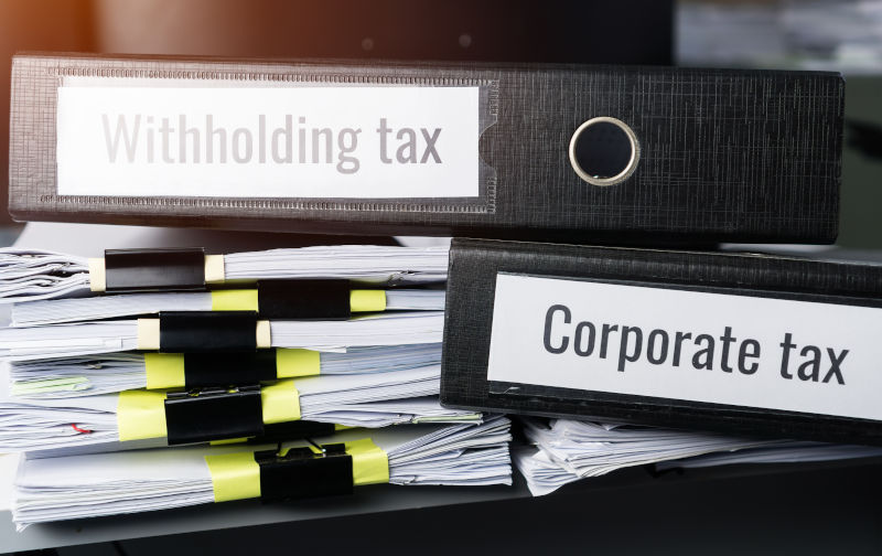 Tax concept, Withholding taxes binders files on document report in business office. Retention taxes is income tax to be paid to government by payer of income rather than by recipient of the income.