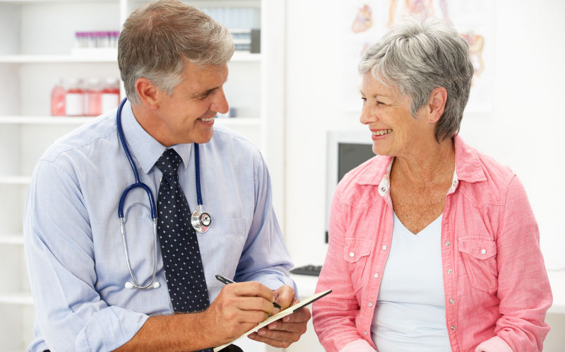 GP Doctor with female patient discussing treatment.