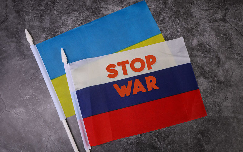 Flag of Russia and Flag of Ukraine with Stop War text.