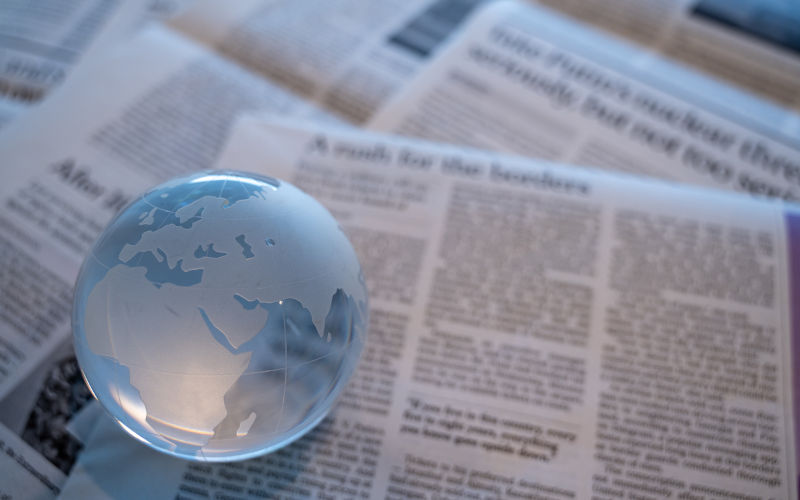 Glass globe on newspapers. Media