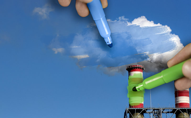 Hands painting pollution blue and polluting chimneys green. Greenwashing malpractice concept