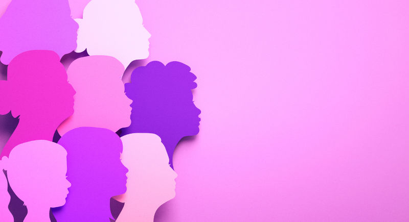 Silhouettes of multicultural women's faces in paper.