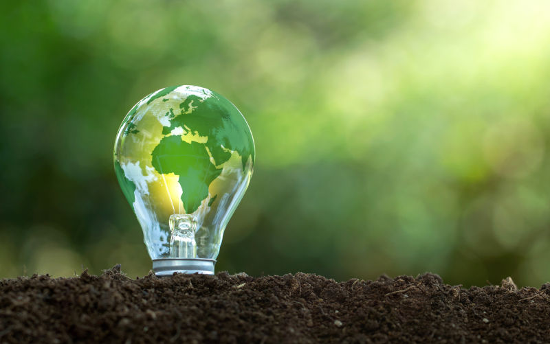 The green world map is on a light bulb that represents green energy Renewable energy that is important to the world.