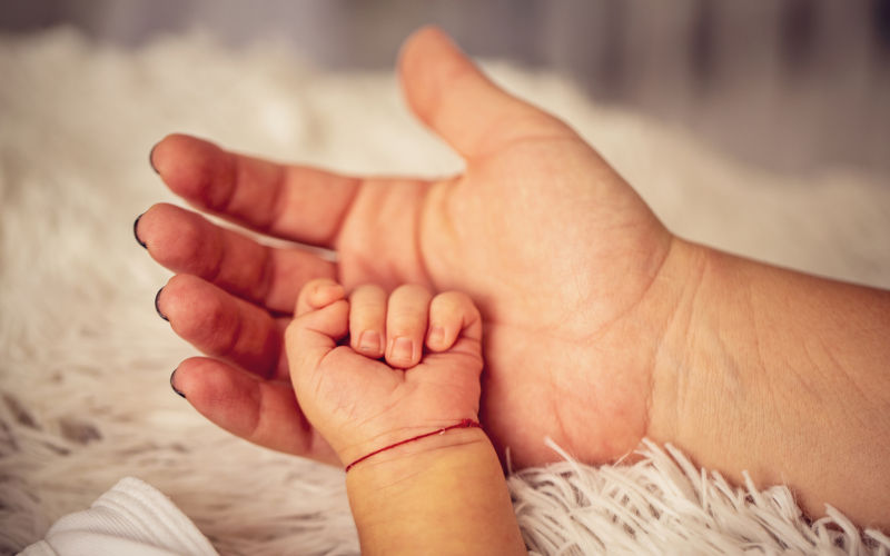 Baby hand on mums palm.