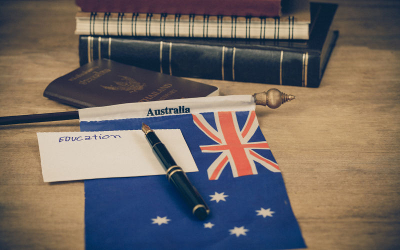 Education in Australia concept,passport and white note on Australia flag.