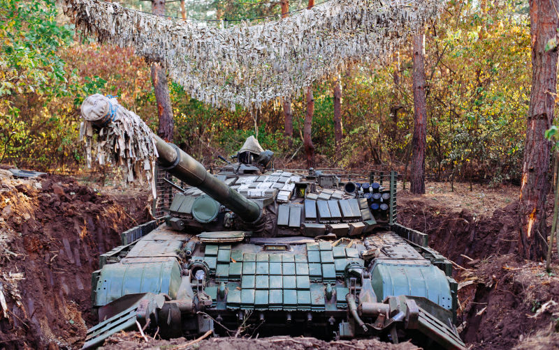 The tank from the hidden position is disguised in the trench Dug in.