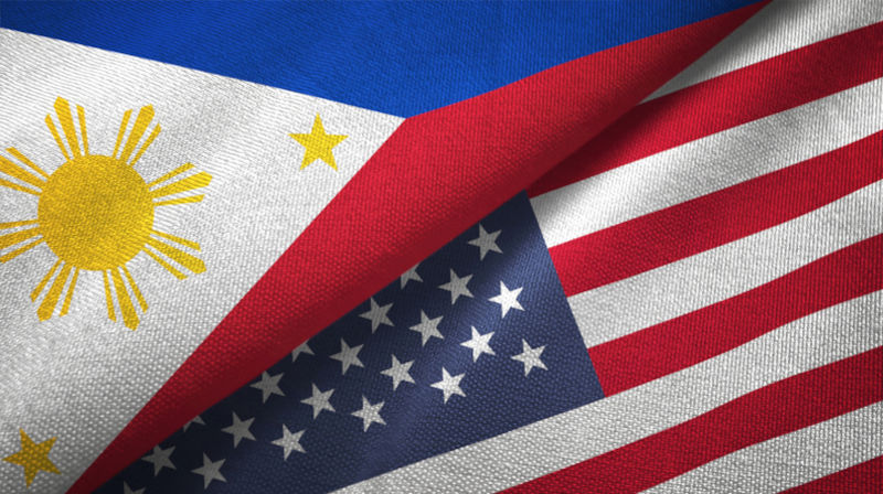 United States and Philippines flag together relations textile cloth fabric texture.