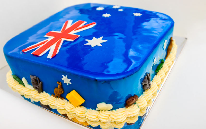 Home baked cake with colours of Australian Flag and decorated with koalas and kangaroos.