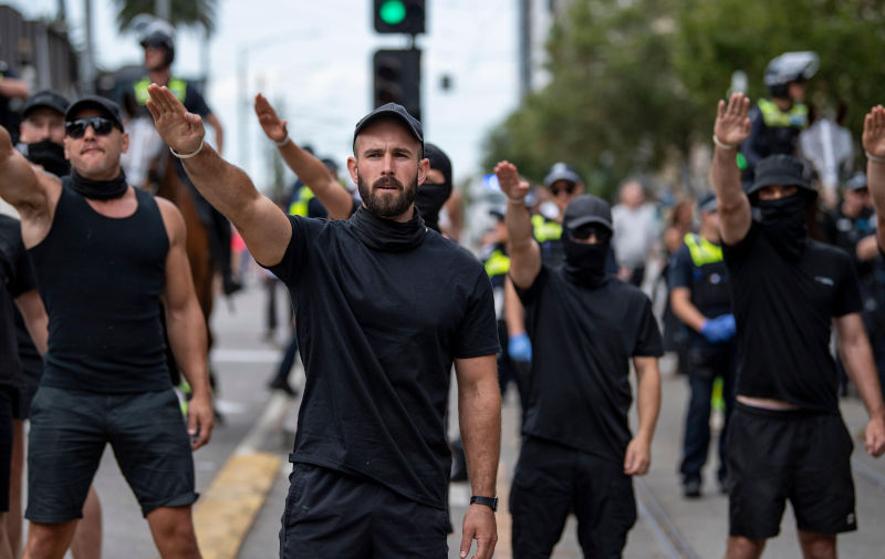 Melbourne, Australia, March 18th 2023. Thomas Sewell and fellow neo-nazis saluting at counter-protesters at a Trans Exclusionary Radical Feminist (TERF) rally, where feminists discredit diverse gender identities, specifically transgender women. Credit: Jay Kogler/Alamy Live News