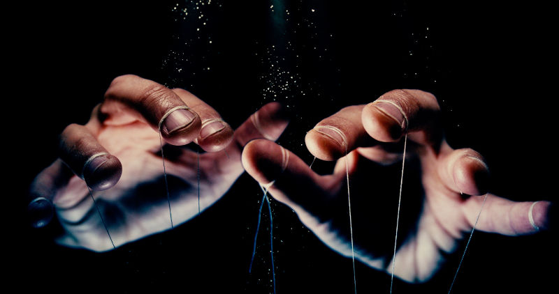 We-are-being-manipulated-concept. Image: iStock We are being manipulated concept. Large scary hands with puppet string tied around fingers