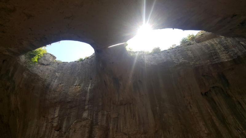 Prohodna Cave in Bulgaria, Eyes of God, sunrays shining threw eye.