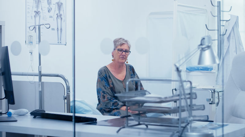 Woman in hospital bed waiting for doctor. consultation in medic office treatment medication diagnosis expertise.