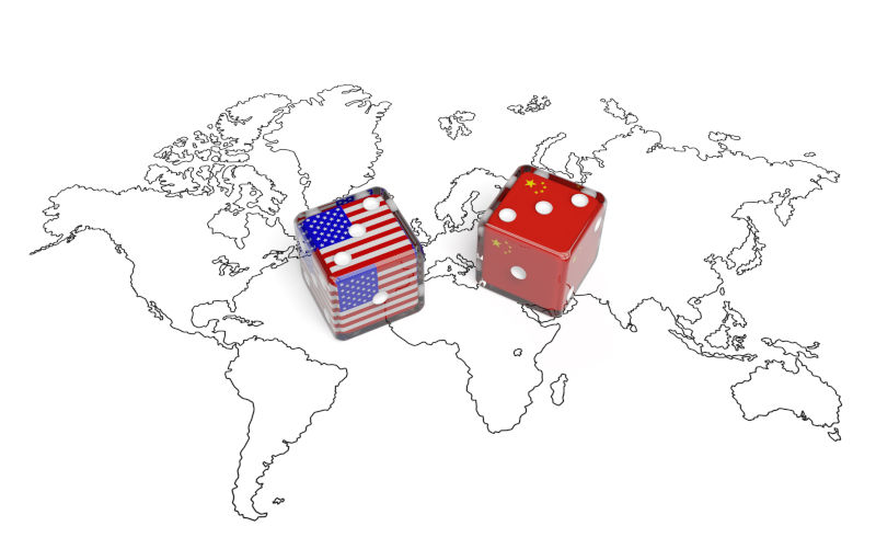 Dices with flags of USA and China on world map.