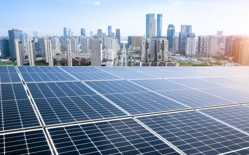 Photovoltaic panels in front of city background