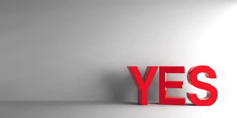 Red-word-YES. Image: iStock Red word YES on grey background.