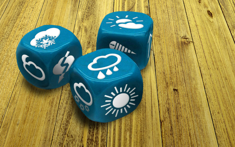 Three dices with weather condition symbols on faces.