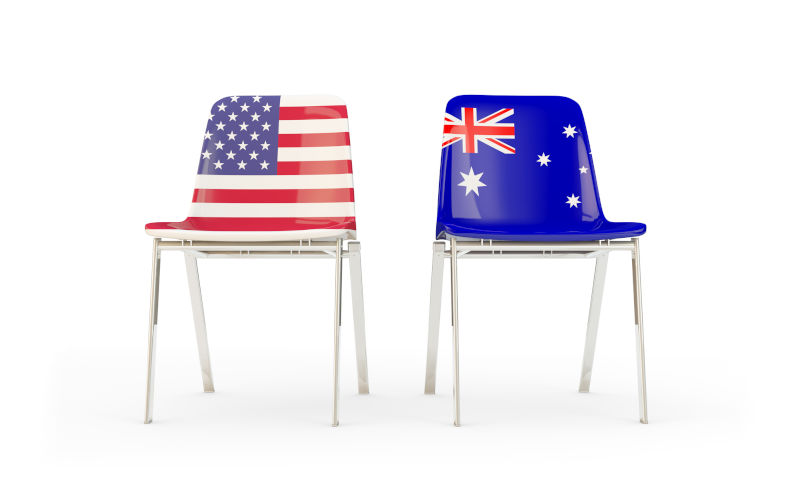 Two chairs with flags of US and Australia isolated on white.