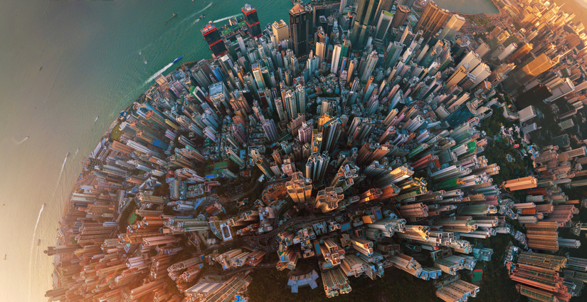 Little planet. Aerial view of Hong Kong Downtown. Financial district and business centers in smart city in Asia. Top view. Panorama of skyscraper and high-rise buildings. Image: iStock