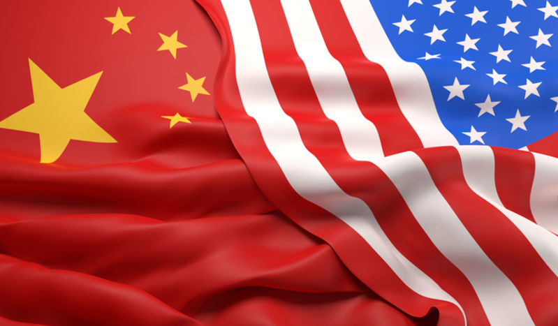 The flags of China and the USA overlapping.