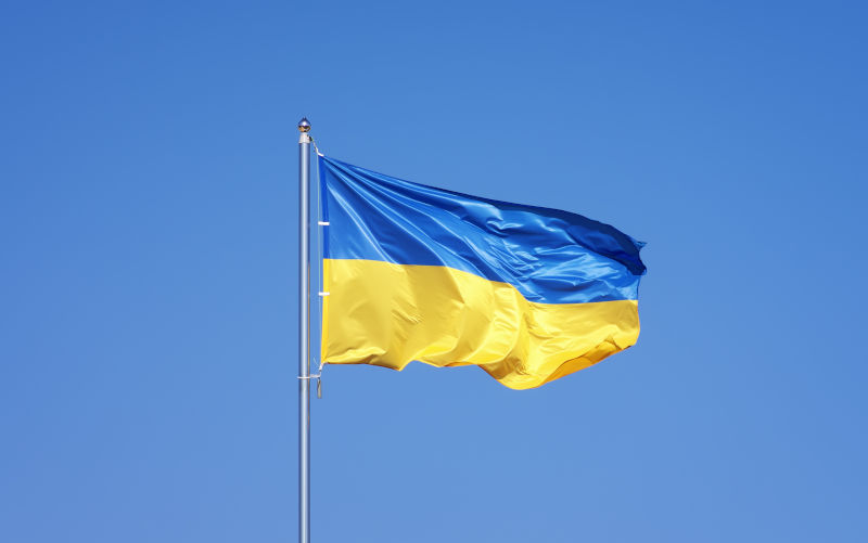 Ukrainian flag on blue sky backgroud.