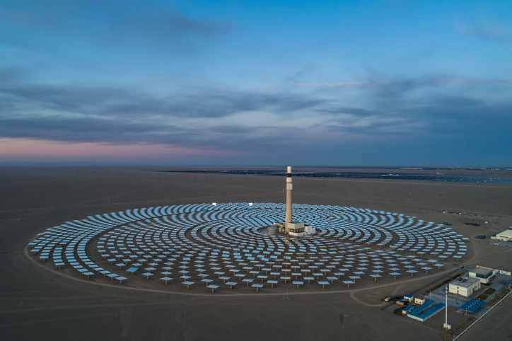 Aerial view of solar thermal plant uses mirrors that focus the sun's rays on a collection tower to produce renewable and pollution-free energy.