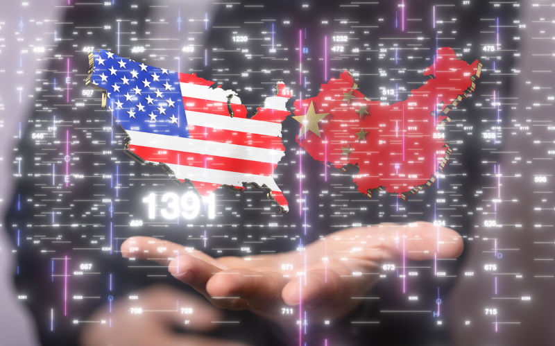 Male hands with 3D render of USA and China.