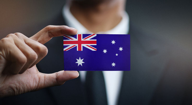 Man Holding Card of Australia Flag.