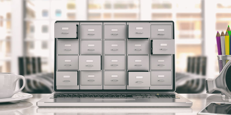 Laptop data storage. Filing cabinet on a laptop screen.