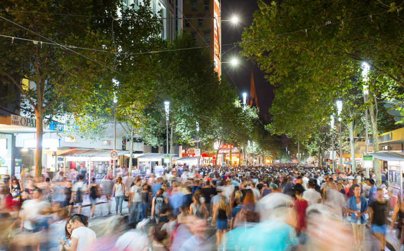 Melbourne's famous Swanston St with large night crowd.