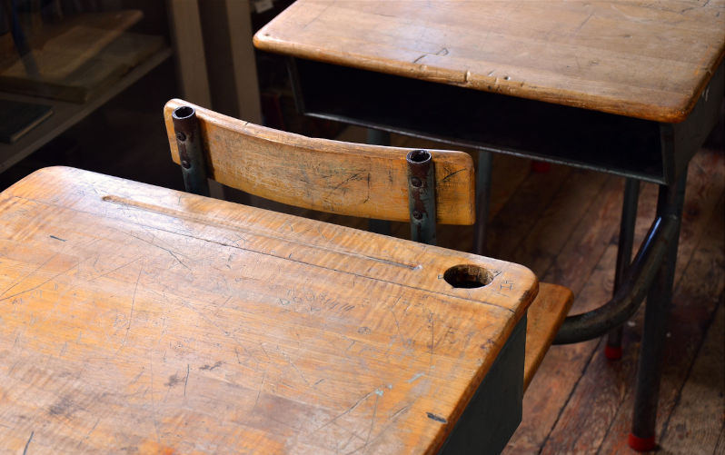 An image of two vintage school desks.