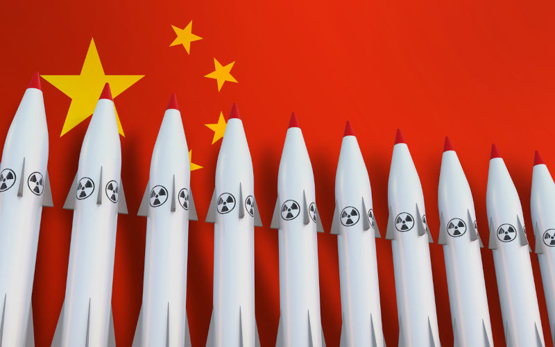 Nuclear missiles in a row and flag of China concept on background - 3D rendered illustration