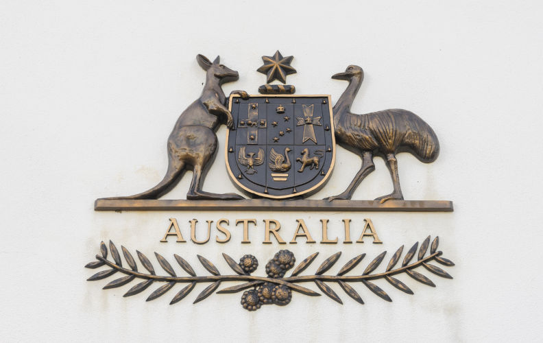 Canberra, Australia - June 28, 2016: View of The Commonwealth Coat of Arms, the formal symbol of the Commonwealth of Australia, in bronze outside the old Parliament House.