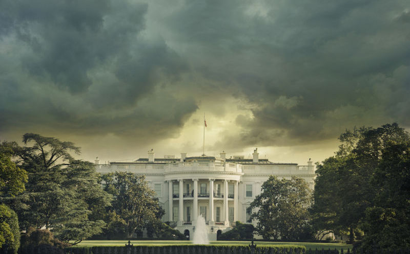 he White House in Washington DC under dark stormy clouds.