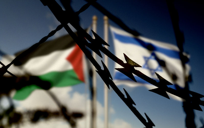 Flags of Israel and Palestine behind the barbed wire.