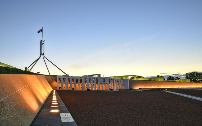 The front entrance of the Parliament House in Canberra at sunset.